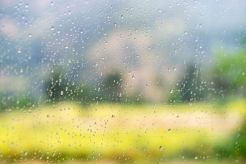 Blurred street scene through car windows with rain drop in Nepal