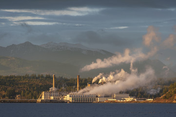 Industrial Pulp Mill in Port Townsend, Washington. The Olympic Mountains provide a backdrop to the...