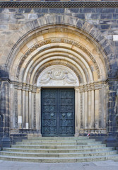 Historic church door with steps and ornamented archway