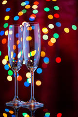 Two glasses for champagne in the New Year's bokeh