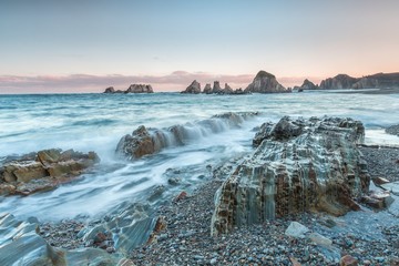 The beach of Gueirúa, small cove of pebbles that stands out above all for its landscape of great beauty with a row of small islands of sharp stone that come out of the ocean