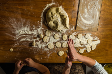 Mom and daughter are making flour out of flour to cook dumplings