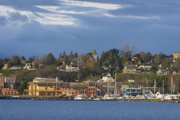 Fototapeta na wymiar Historic Port Townsend, Washington Waterfront at Sunrise. By the late 19th century, Port Townsend was a well-known seaport. Beautiful Victorian houses and buildings can be seen most everywhere.