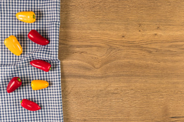 Peppers on wooden background.
