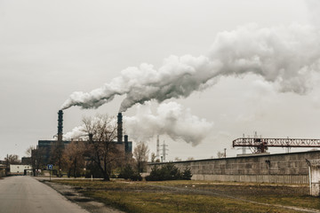 Fototapeta na wymiar mining enterprise with smoke stacks. Dirty smoke on the sky, ecology problems.