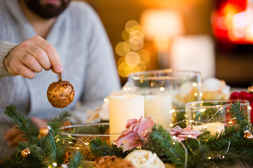 Bearded man decorating christmas table