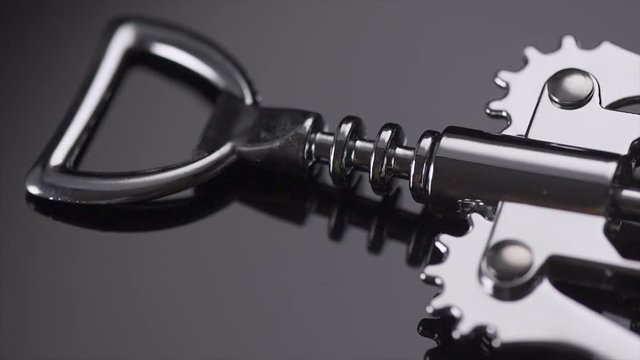 Mechanical corkscrew on a black background. Rotation 360 degrees. 4K UHD video