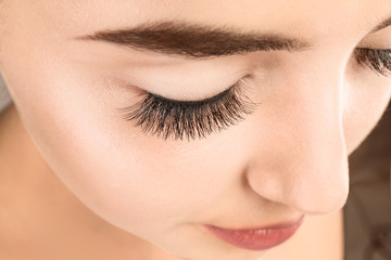 Beautiful young woman with eyelash extensions, closeup