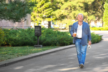 Handsome mature man walking in park