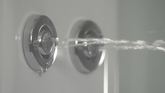 Shower cabin, stall. Shower head with running water in a bathroom