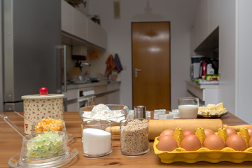 Tisch voller Zutaten für Weihnachtskekse, mit Blick in die Küche