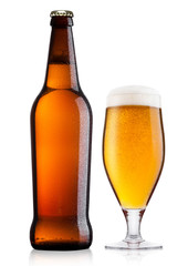 Cold bottle and glass of lager beer with foam