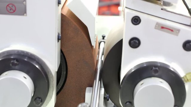 Centerless grinding machine operate without  coolant ; industrial manufacturing equipment background