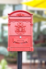 Red mailbox in front of a house.