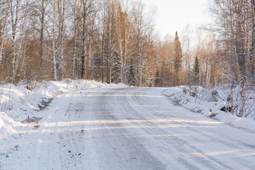Fototapeta na wymiar The winter road in the wood. The road in Siberia in the winter.