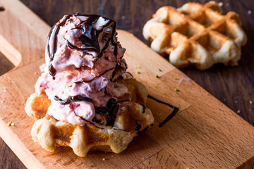 Belgium Waffle with ice cream on wooden surface.