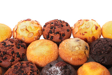 Muffin chocolate chip cup cake or cupcake various flavor several lots many in a row line border isolated on white background photo