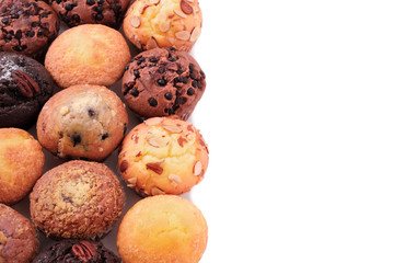 Muffin chocolate chip cup cake or cupcake various flavor several lots many in a row line side border isolated on white background photo