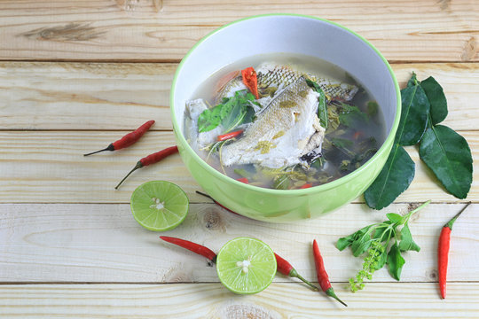Gerres oyena or Common silver-biddy fish of hot and sour soup on wooden floor.