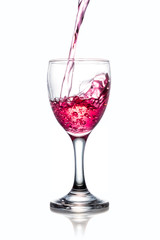 Red pouring water on a glass isolated on white background. Clipping path