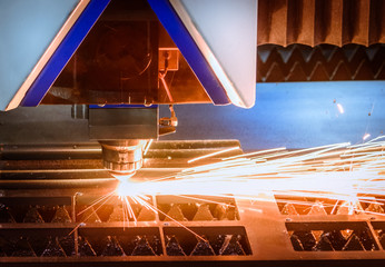 Closeup Laser steel cutting machine with flame.