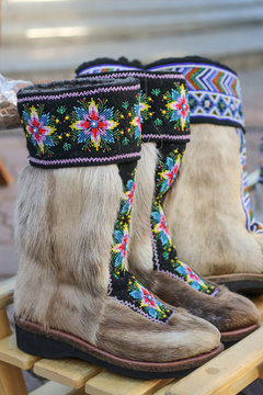 Traditional northern footwear. Fur of reindeer boots