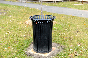 Black garbage bin in the public park, Canada