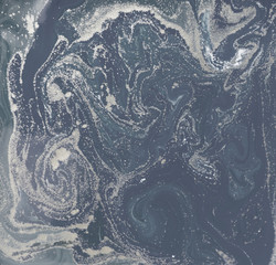 Liquid gold marbled pattern. Pale blue background