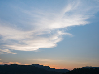 the beautiful blue sky with cloudy background and silhouette mountain in the evening