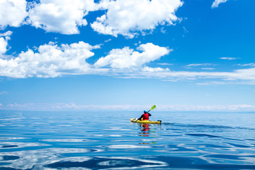 A man in a sea kayak on Lake Baikal - obrazy, fototapety, plakaty