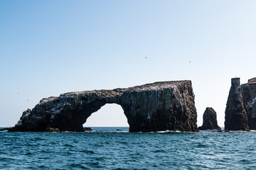 Arch Rock natural bridge and other nearby volcanic rock formations at East Anacapa Island in Channel Islands National Park off the coast from Ventura, California.