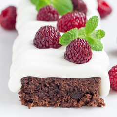 Homemade brownies with cream cheese frosting and raspberry, square