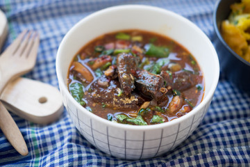 Fish canned in tomato sauce with herb salad spicy