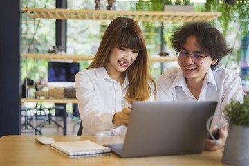 Young business couple using laptop
