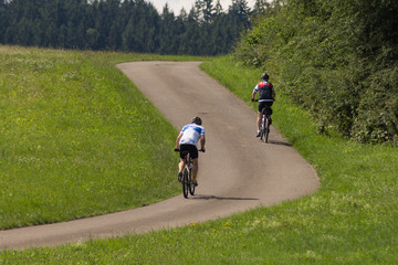 cyclists in a distance view on a summer sunny day © rudolfgeiger