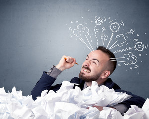 Businessman behind crumpled paper