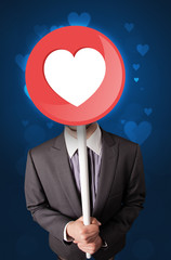 Businessman holding heart sign