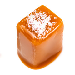 Salty Caramel candy and caramel topping isolated on a white background.Golden Butterscotch toffee...