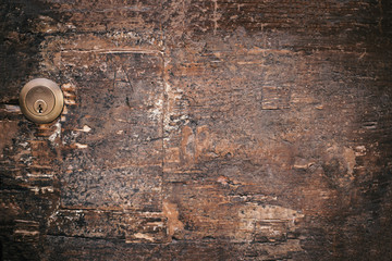 Wood door lock on old vintage ancient wooden background. Old texture of bark wood.