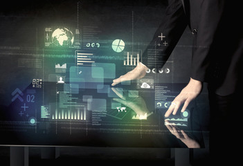 Businessman touching interactive modern desk with technology icons