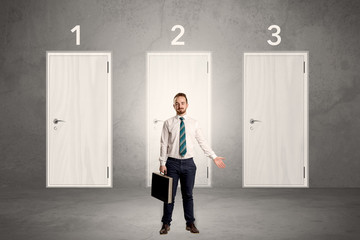 Fototapeta premium Businessman thinking in front of three doors