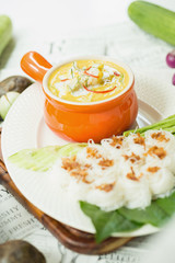 Curry crab, Seafood with Yellow curry sauce in orange ceramic pot, on tablecloths background