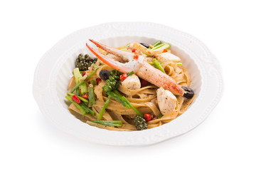 Spicy Seafood Spaghetti on a white ceramic dish isolated on white background