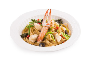 Spicy Seafood Spaghetti on a white ceramic dish isolated on white background