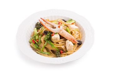 Spicy Seafood Spaghetti on a white ceramic dish isolated on white background