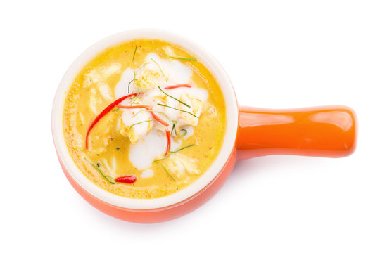 Curry Crab, Seafood With Yellow Curry Sauce In Orange Ceramic Pot, Isolated On White Background