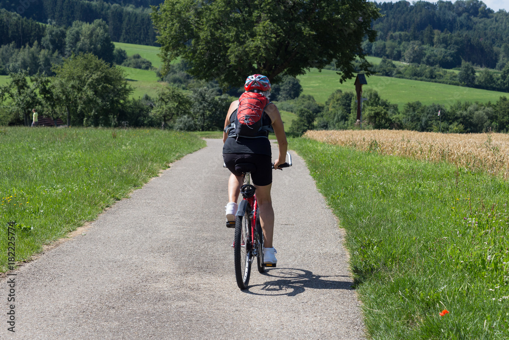 Wall mural cyclists on a summer sunny day in south german countryside