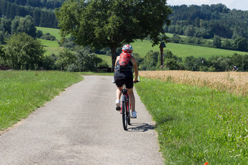cyclists on a summer sunny day in south german countryside © rudolfgeiger