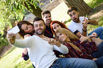 Group of friends taking selfie in urban background