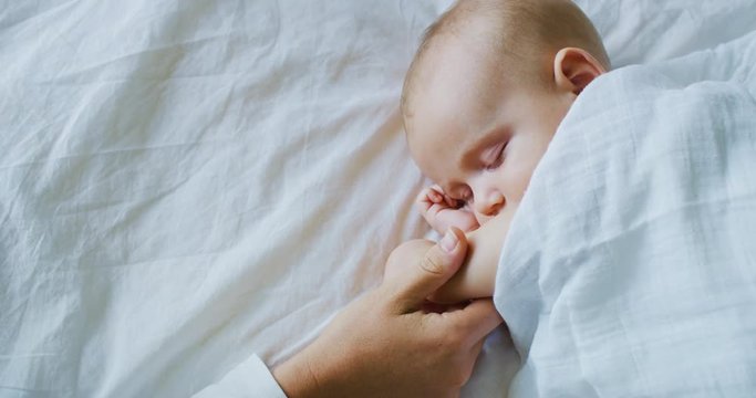 Mother Putting Baby to Sleep